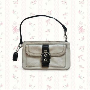 Coach Hampton ivory leather wristlet with a brown buckle detail